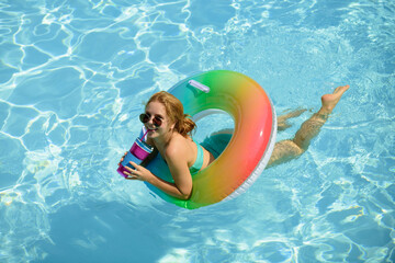 Summertime vacation, summer holiday. Woman on swim ring. Summer mood concept. Pool resort.