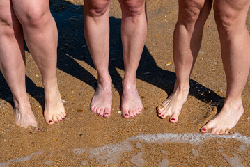 Fototapeta na wymiar Women feet in the sand