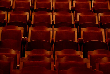 Fototapeta premium numbered theater chairs with red velvet