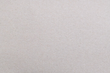 Texture of old organic cardboard, beige paper, background for design, copy space. Recyclable material, has inclusions of cellulose