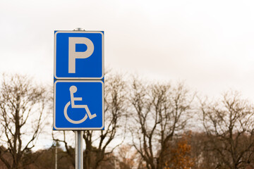 Handicap parking sign by a parking lot..