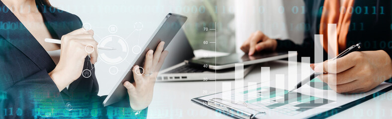 Business people using tablets And using his finger to touch the screen With a business graph showing up in a virtual screen.New startup ideas and business growth concept.