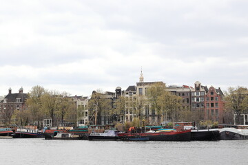 Fototapeta na wymiar Amsterdam Oosterdok View with Historic Buildings and Boats