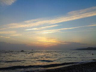 sea landscape is a pebbly beach with waves in white foam