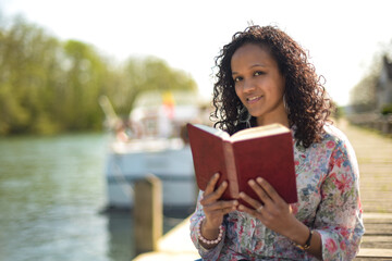 metis woman reading a book in a natural setting