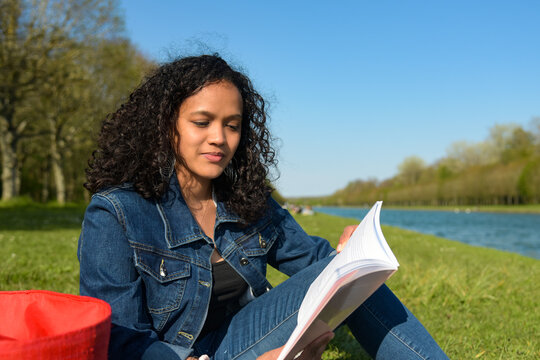 metis woman reading a book in a natural setting