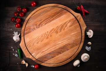 Empty pizza board on dark wooden table, Top view.