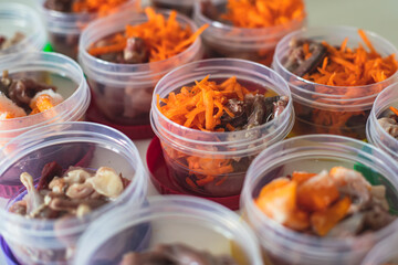 Process of preparing bowls with natural raw pet dog food at home, preparation of healthy raw barf for cats dogs, with duck, turkey, offals, meat, vegetables, assorted fresh food portions in containers