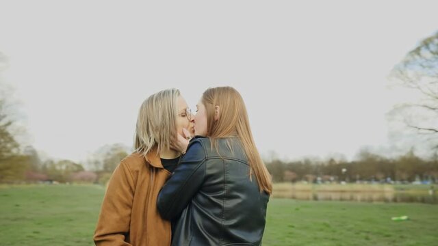 EPIC orbit: Stylish LGBT couple huggs and kisses in park
