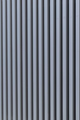 iron structure with straight metal bars forming a striped structure on a wall