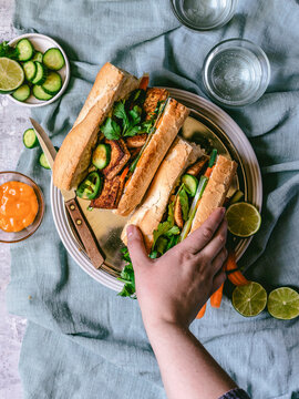 Vegetarian Banh Mi - hand in frame and vibrant