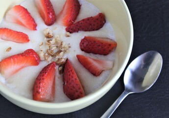 semolina porridge with strawberries and nuts on plate breakfast healthy morning food