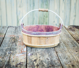 Empty old wooden basket on wooden table. Vintage background.