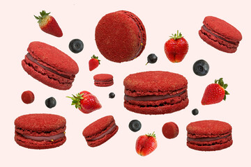 Red  french macaroons and berries strawberries, blueberries, with  falling or flying in motion on a light yellow background.