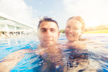 Couple relaxing in swimming pool