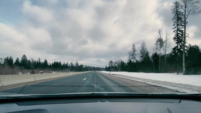 driving in a car along the highway to the port of Ust-Luga on a spring day