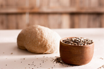 Bread dough with a boul full of seeds to use in it. Copy space. Selective focus