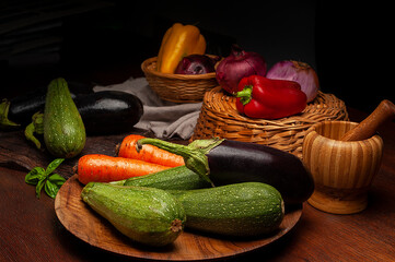 assorted vegetables on wooden table wicker basket and pepper mortar still life style of vegetables