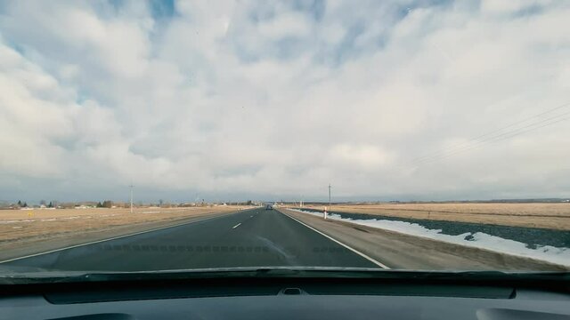 driving in a car along the highway to the port of Ust-Luga on a spring day