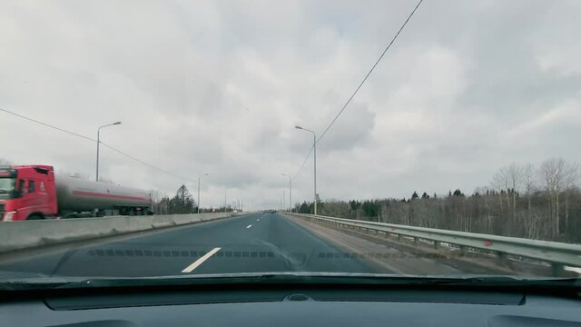 driving in a car along the highway to the port of Ust-Luga on a spring day