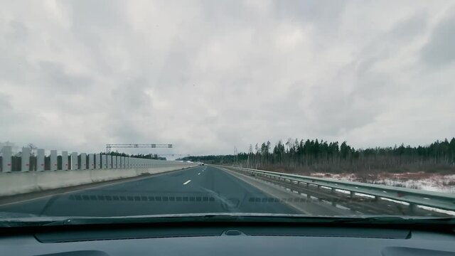 driving in a car along the highway to the port of Ust-Luga on a spring day