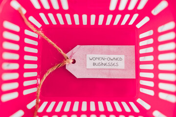 women-owned businesses tag with pink shopping basket, supporting equality