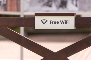 Sign with free Wi-Fi. Sign on the fence about free Internet.