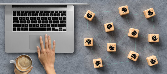 Dice with Cookie icons and a laptop conceptual of the GDPR regulations introduced by the EU governing data collection and privacy of information for individuals online. - 430705906