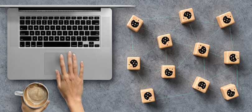 Dice with Cookie icons and a laptop conceptual of the GDPR regulations introduced by the EU governing data collection and privacy of information for individuals online.