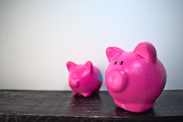 Fototapeta premium Two hand-painted piggy banks on a shelf
