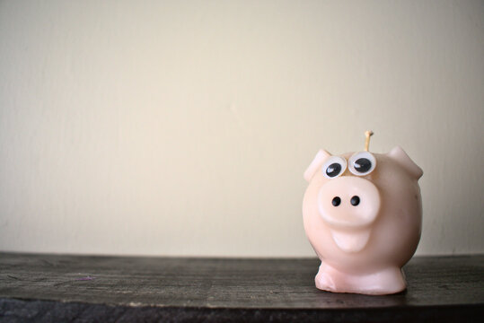 Pig Shaped Candle On A Wooden Ledge