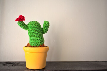 Pot with cactus made of worsted with red flower
