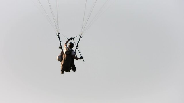 Paragliders taking pictures with the selfie stick while flying paragliding in the sky.Parachute atmosphere drag parachutes parasailing parascending parasail fly flight air sport tourism freedom nature