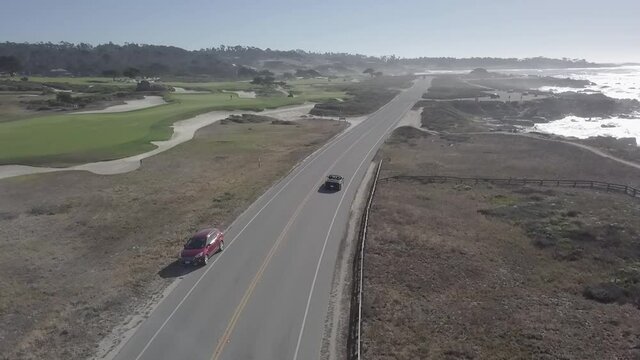 Sightseeing vacation along California state route 1 following vehicle aerial view along coastline