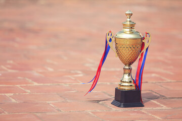 Gold winners trophy or champion cup on floor 