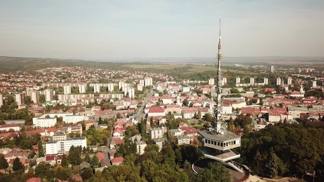 Cinematic aerial drone orbiting shot of the TV Tower of Miskolc, fourth largest city and a major industrial hub, Northern regional center of Hungary, capital of Borsod-Aba&uacute;j-Zempl&eacute;n county