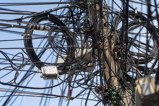 Messy cables on electric poles in Thailand