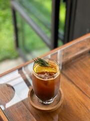 Orange americano Coffee drink on wood table. Cafe concept