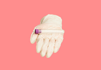 lab experiment tube in glove palm hand on isolated pink background with copy space