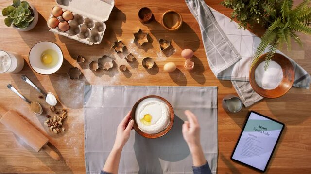 Top view of unrecognizable woman baking biscuits, desktop concept.
