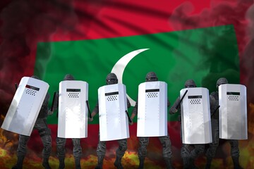 Maldives protest fighting concept, police special forces in heavy smoke and fire protecting state against demonstration - military 3D Illustration on flag background