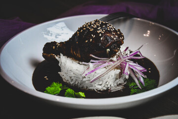 Mexican mole with chicken legs and steamed rice