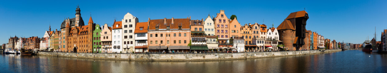 Fototapeta na wymiar Panoramic view of Motlawa river embankment in Gdansk in sunny spring day, Poland.