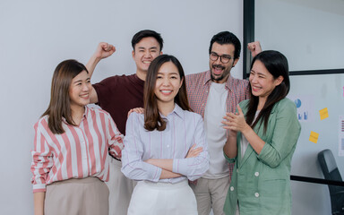 Group of mixed race people wearing casual business shirt, smiling with happiness and success, congrats and give applause to asian female leader.