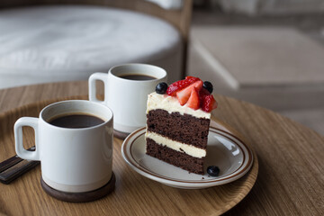 chocolate cake in white plate on wooden table background.