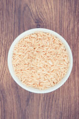 Vintage photo, Heap of brown rice in glass bowl, healthy nutrition