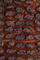 Plums with herbs and spices in the oven. Food background. Top view. Selective focus of the image.