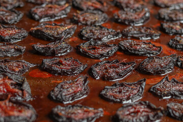 Plums with herbs and spices in the oven. Food background. Selective focus of the image.
