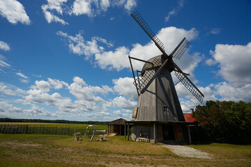 old wooden wind-mill on a colorful summer day