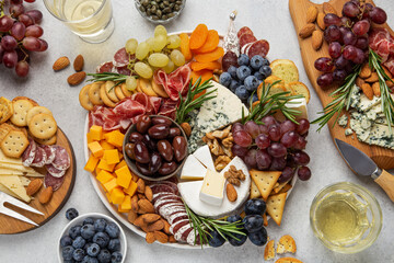 Appetizers boards with assorted cheese, meat, grape and nuts